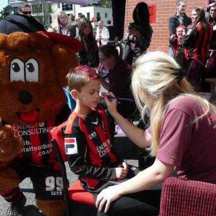 Facepainting boy with cherries mascot.jpg