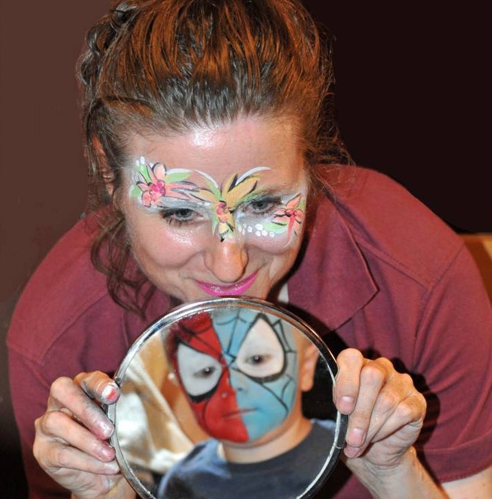 Ronnie showing a child their face in a mirror